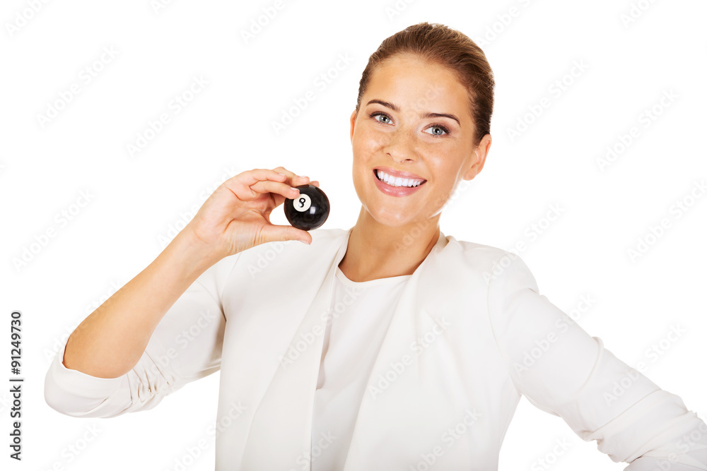 Happy businesswoman holding eight billiard ball Happy businesswoman holding eight billiard ball