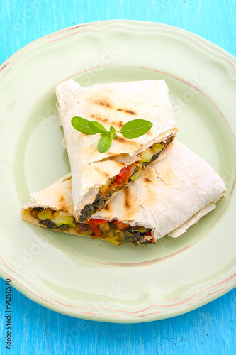 burrito with grilled vegetables and sauce with cheese