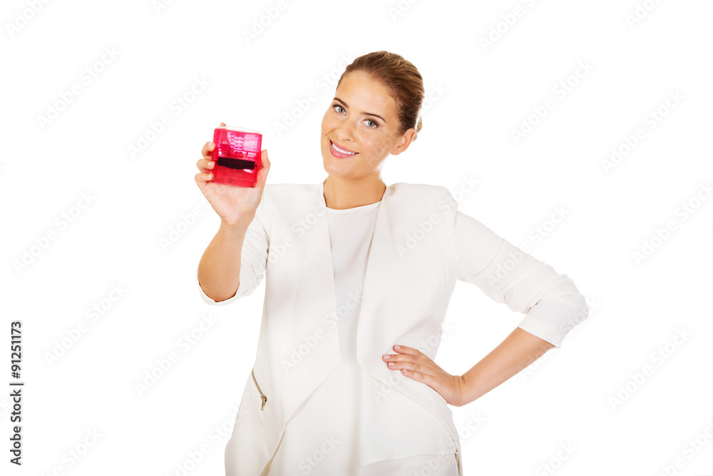 Young businesswoman holding pink rubber stamp Young businesswoman holding pink rubber stamp