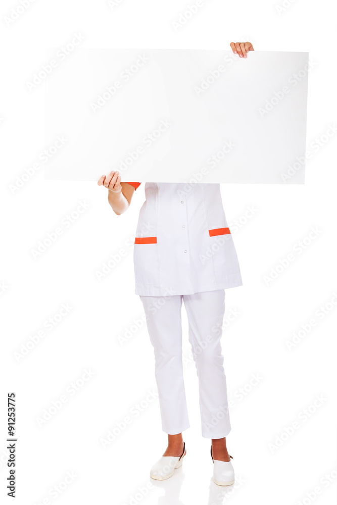 Female doctor or nurse holding empty banner Female doctor or nurse holding empty banner