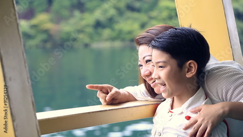 Young asian mother with little son stand on deck of cruise ship,at HAGONE Japan . photo