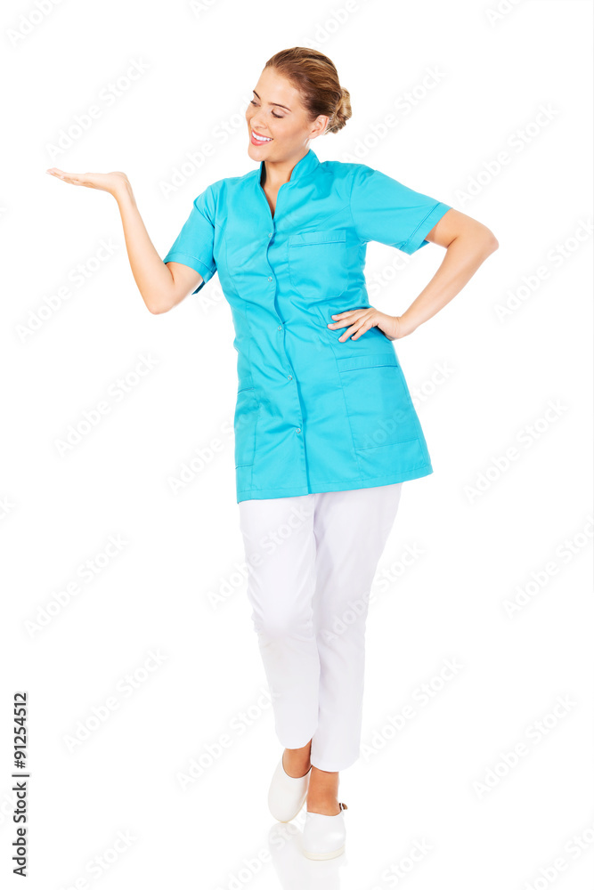 Young female doctor showing something by hand Young female doctor showing something by hand