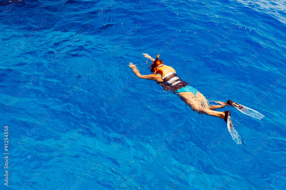 Young woman in swimsuit snorkeling