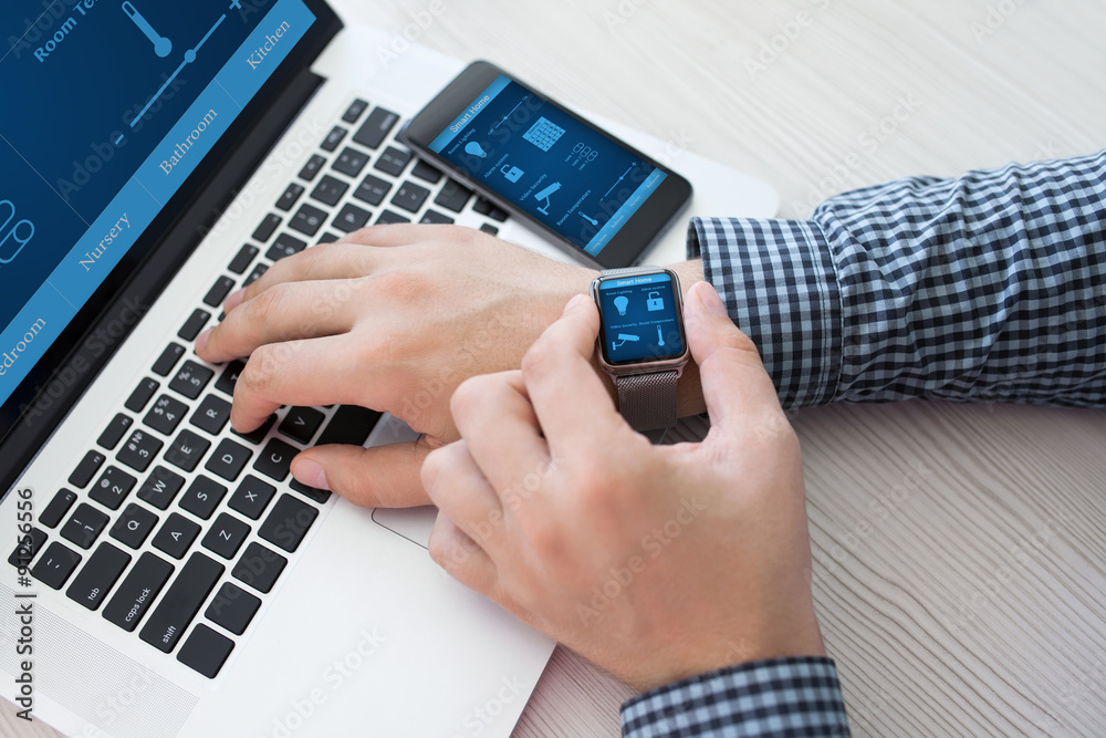 man hand in watch with smart home computer and phone man hand in watch with smart home computer and phone