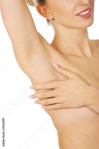 Beautiful woman examining her breast.
