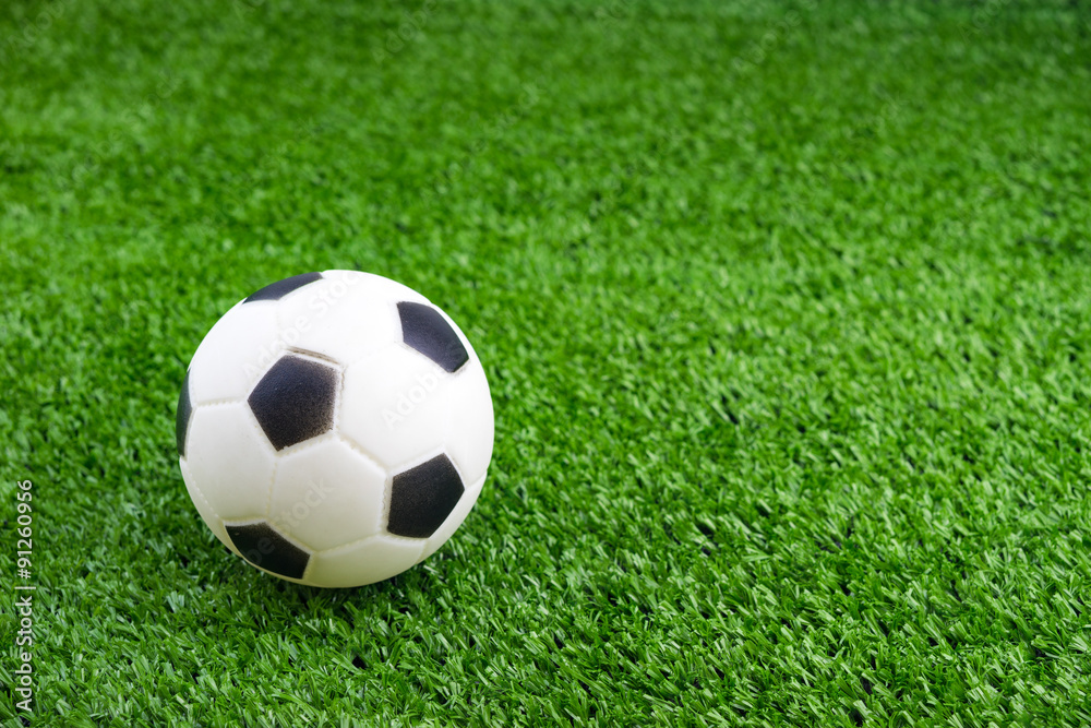 Toy ball on artificial grass background