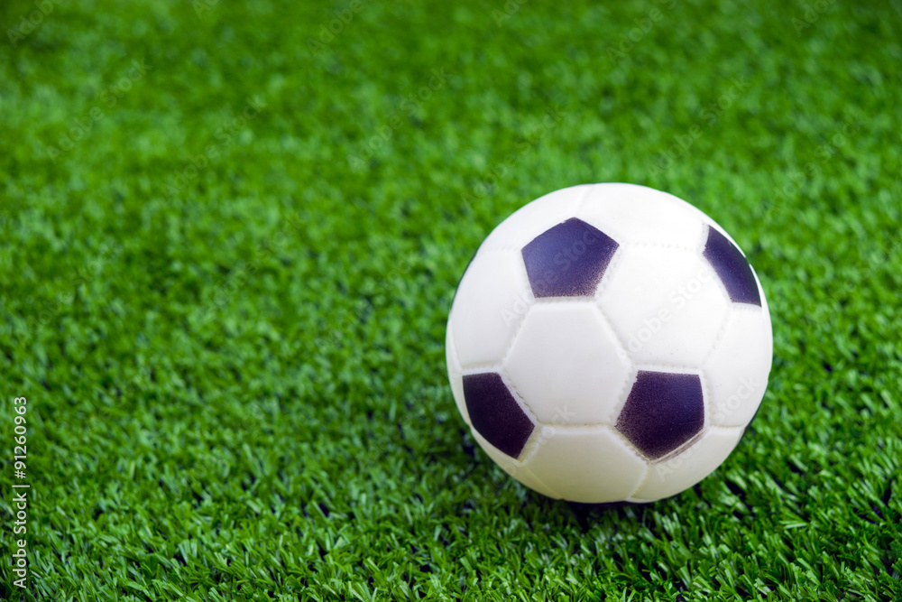 Toy ball on artificial grass background