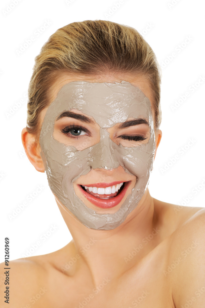 Young happy woman with facial mask.