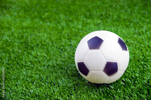Toy ball on artificial grass background