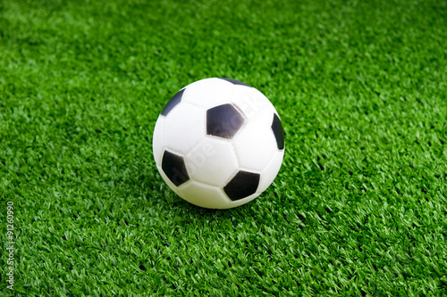 Toy ball on artificial grass background