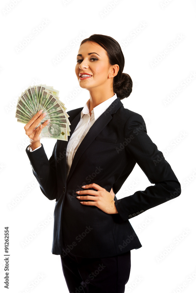 Businesswoman holding a clip of polish money Businesswoman holding a clip of polish money