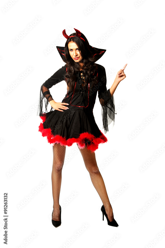 Woman wearing devil clothes pointing up Woman wearing devil clothes pointing up