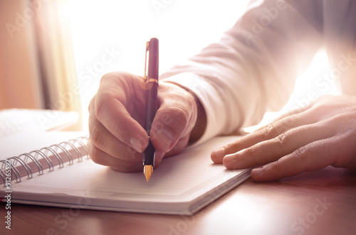 Businessman writing on a notebook. Image can be used for several purposes like: background, website banner, promotional materials, poster, presentation templates, advertising and printed materials.