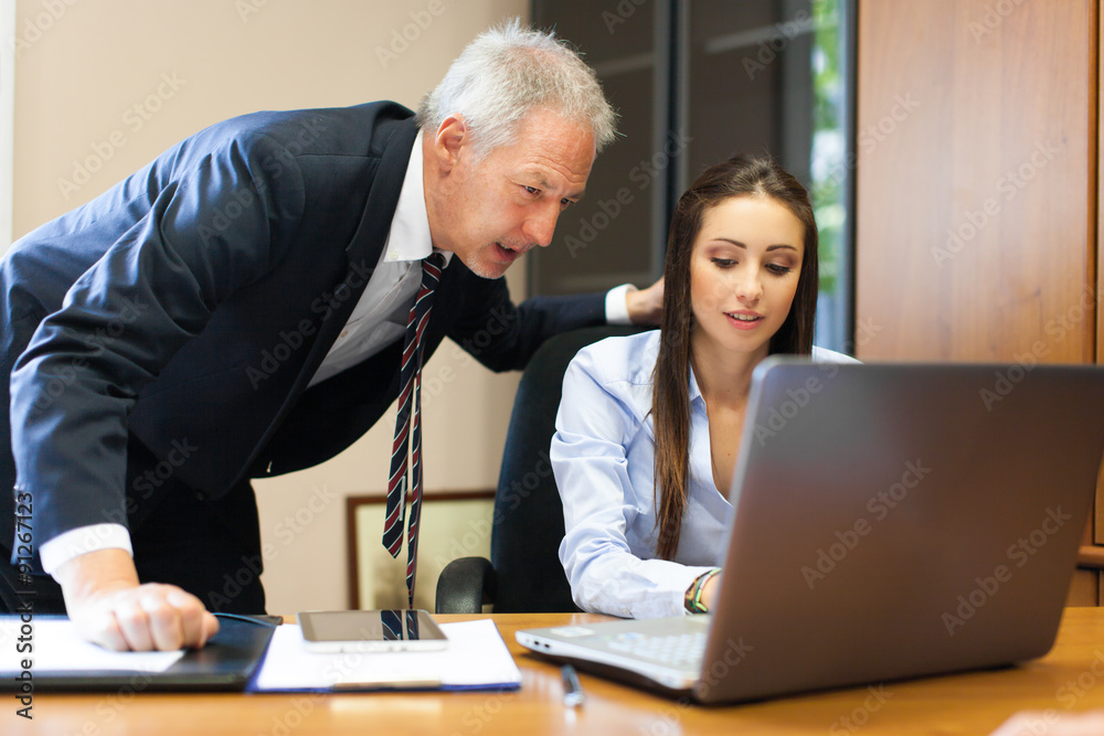 Two business partners discussing plans or ideas at meeting Two business partners discussing plans or ideas at meeting
