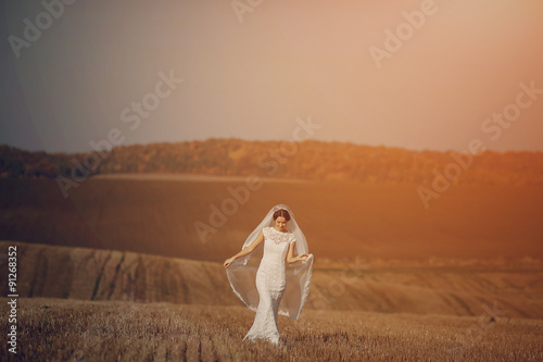 happy wedding couple in a field