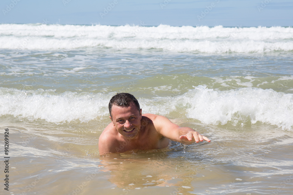 Man having fun at the beach during summertime