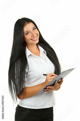 Young beautiful girl writing notes in her notebook