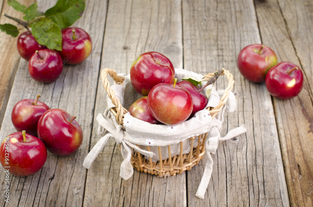 apples on a wooden table and basket apples on a wooden table and basket