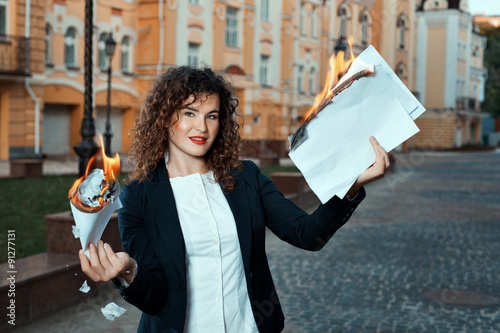Girl is holding the documents that burn.