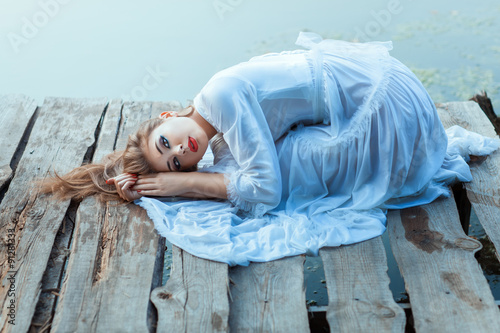 Canvas Print On the pier lay a lovely girl.