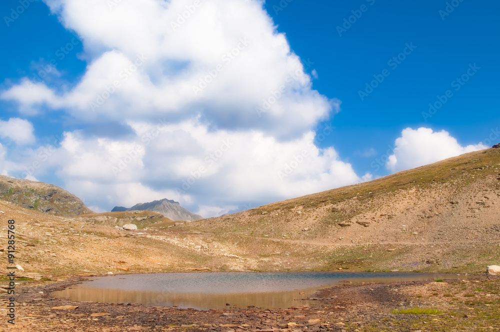 landscape of an alpine lake with cloudy sky