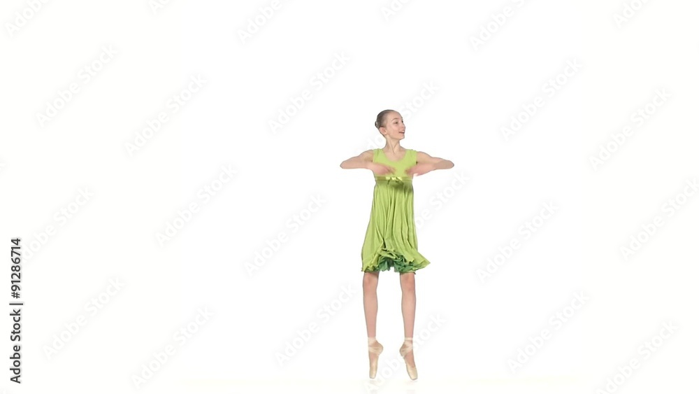 Ballerina in green dress posing on a white. slow motion Ballerina in green dress posing on a white. slow motion