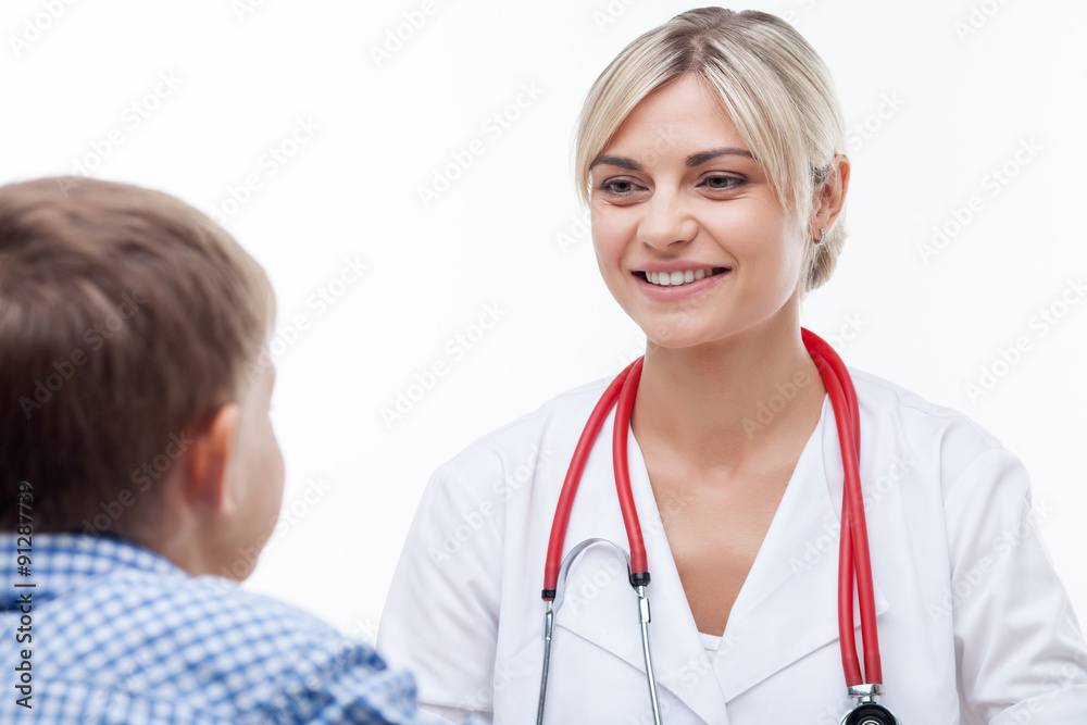 Pretty young female doctor is talking with child Pretty young female doctor is talking with child