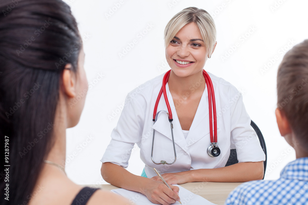 Cheerful young female doctor is treating child Cheerful young female doctor is treating child