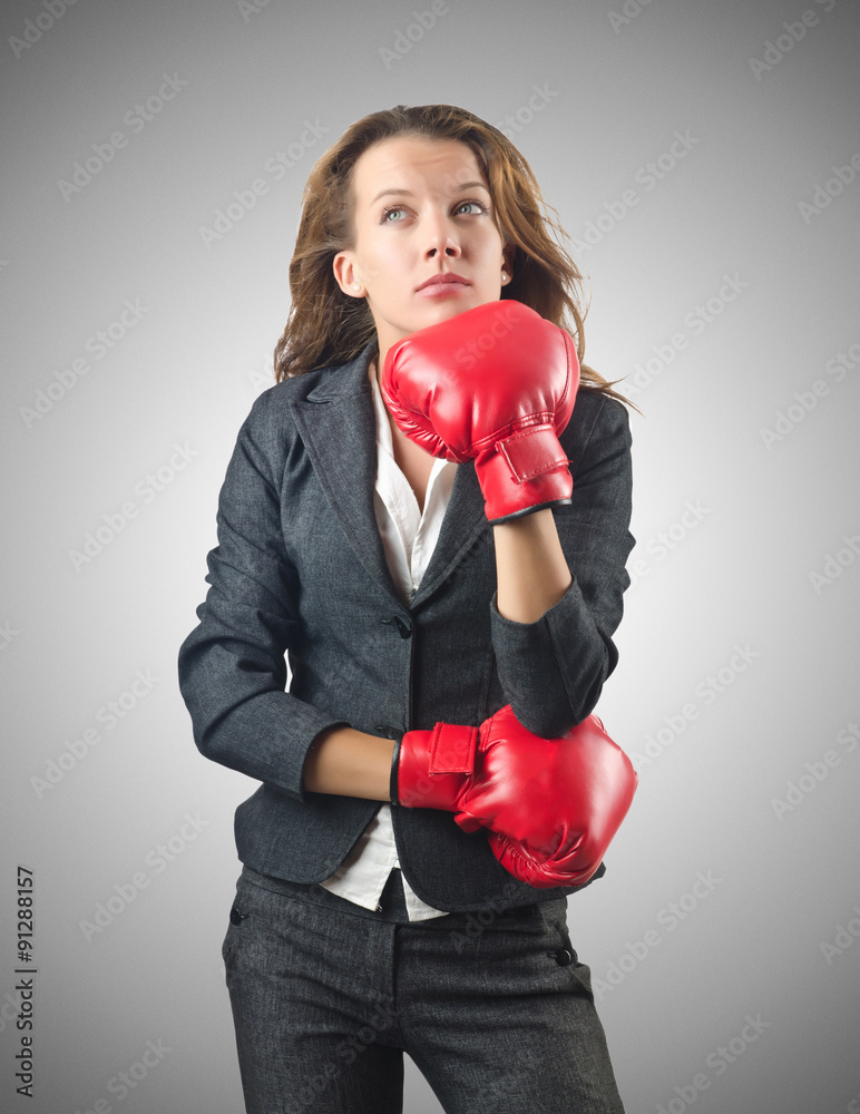 Young businesswoman in boxing concept Young businesswoman in boxing concept