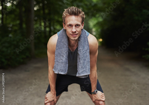 Man with Towel on his Neck Resting After Exercise