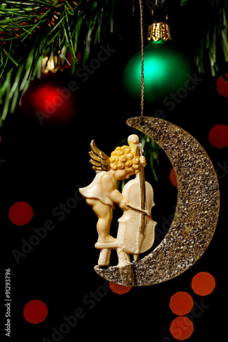 Antique angel Christmas decoration hanging on the tree. Close up. photo