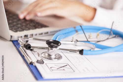  doctor taping on a computer keyboard