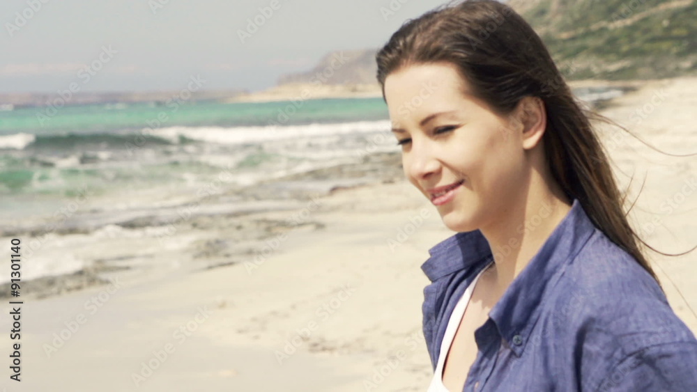 Young, happy woman walking on beach, slow motion shot at 240fps Young, happy woman walking on beach, slow motion shot at 240fps