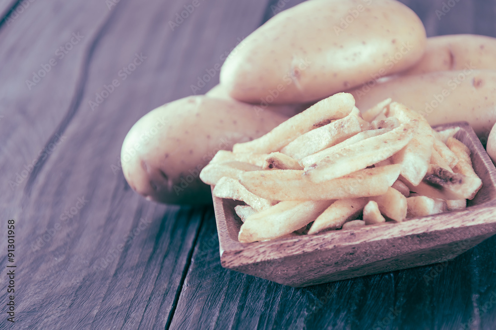 french fries on wood background - soft focus with vintage film f french fries on wood background - soft focus with vintage film f