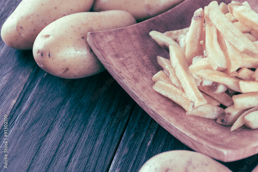french fries on wood background - soft focus with vintage film f french fries on wood background - soft focus with vintage film f