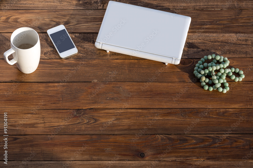 Wooden Desk with Laptop Telephone Mug and Rosary Rough Planked Wood Pattern with Modern Gadgets Located on It Wooden Desk with Laptop Telephone Mug and Rosary Rough Planked Wood Pattern with Modern Gadgets Located on It