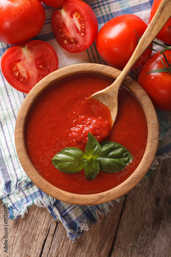 Fresh tomato sauce in a wooden bowl closeup. vertical top view 