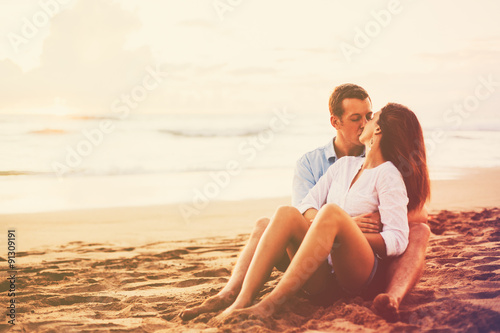 Romantic Couple Enjoying Beautiful Sunset at the Beach