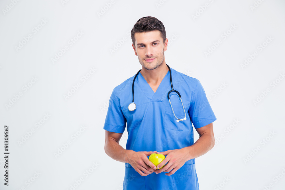 Portrait of a handsome male doctor holding apple Portrait of a handsome male doctor holding apple
