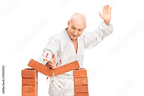 Senior breaking a brick with his bare hand
