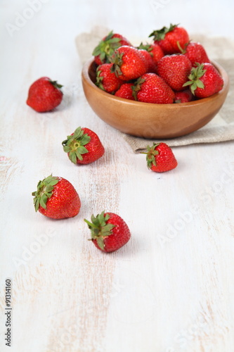Ripe strawberry in a wooden bowl