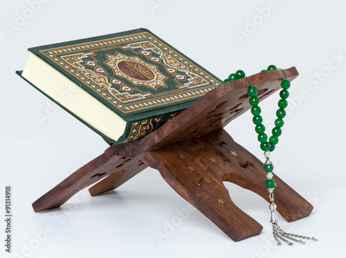 Quran with prayer beads on book stand