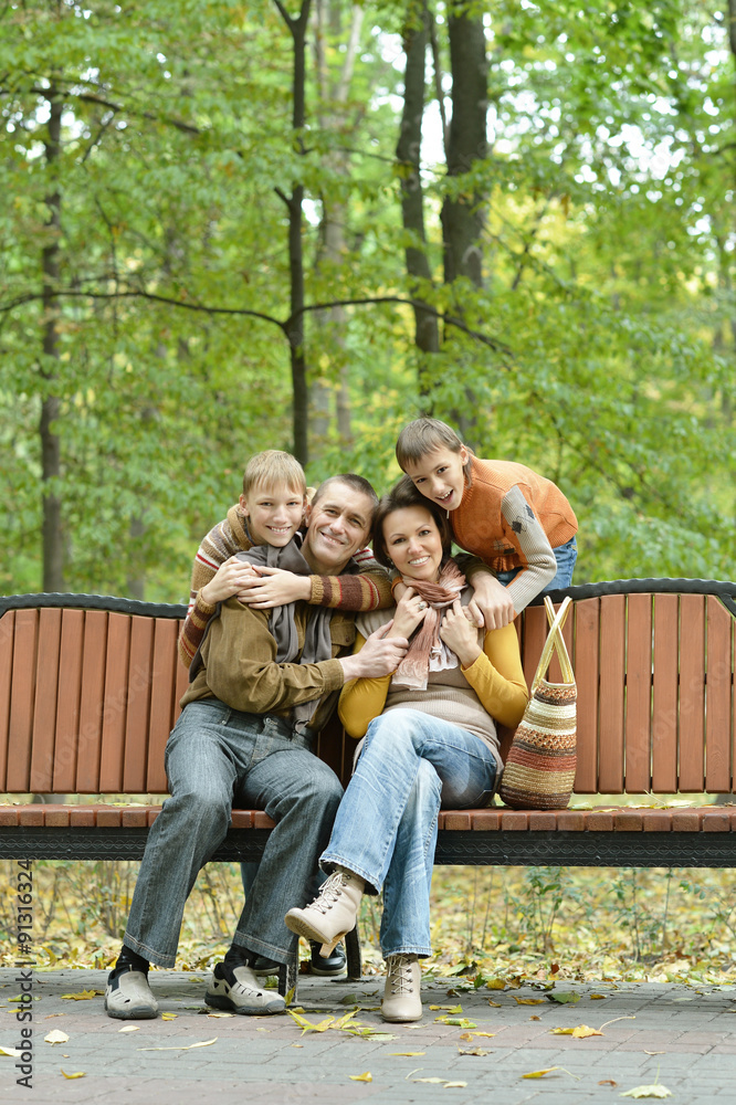  Family relaxing in autumn park