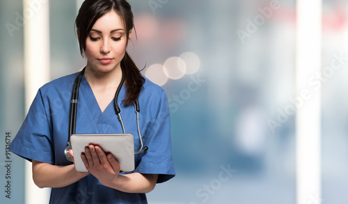 Nurse using a digital tablet. Large copy-space