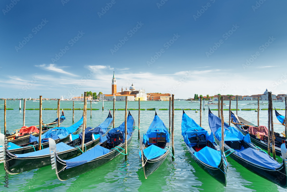 A row of gondolas parked beside the Riva degli Schiavoni. Venice