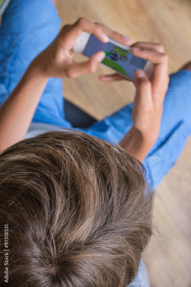 Fototapeta premium Close up on a boy with a mobile phone