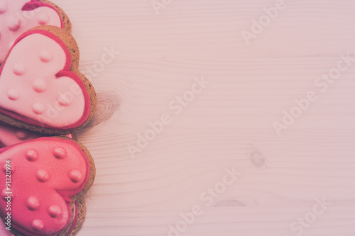 Delicious fresh cookies in the shape of a heart on a wooden background.