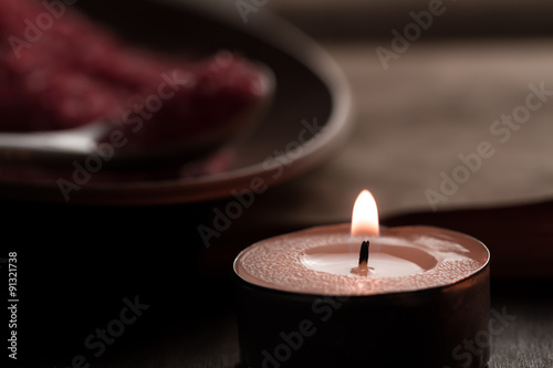 Beautiful Spa composition with aroma candles and empty vintage open book on wooden background. Treatment, aromatherapy
