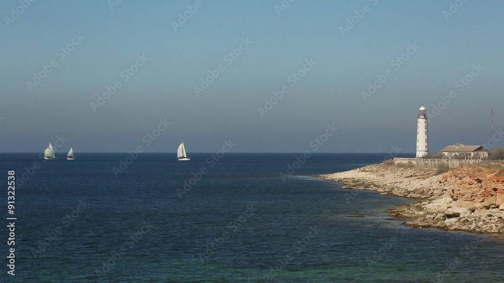 sailing race on the background of the lighthouse sailing race on the background of the lighthouse