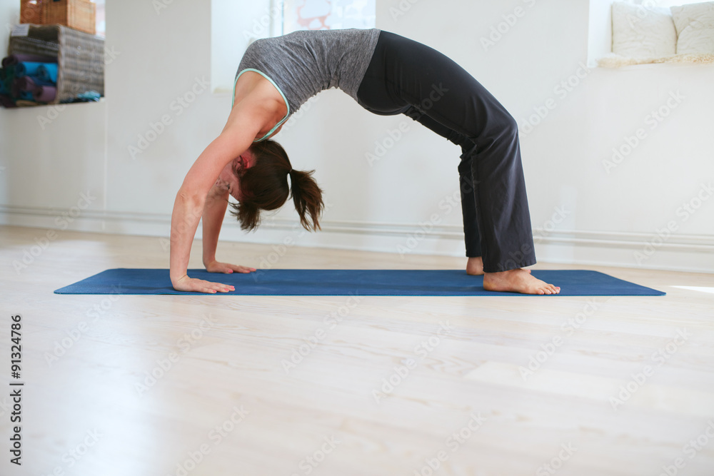 Woman doing yoga - Urdhva Dhanurasana pose Woman doing yoga - Urdhva Dhanurasana pose